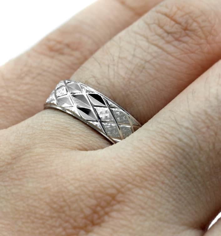 Der Mann hat einen silbernen Ehering an seinem Ringfinger