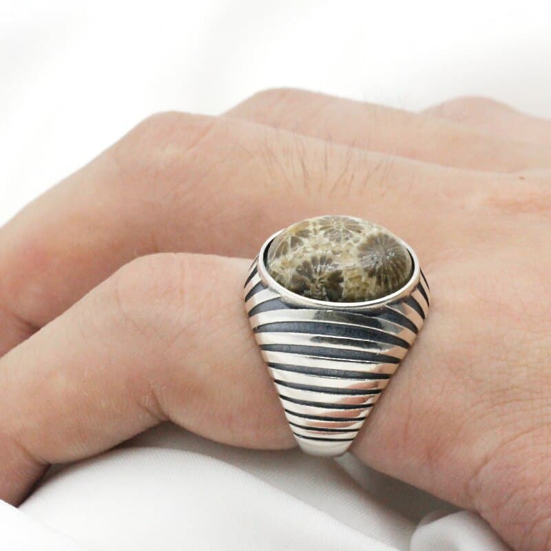 Man wears ring with big stone on index finger